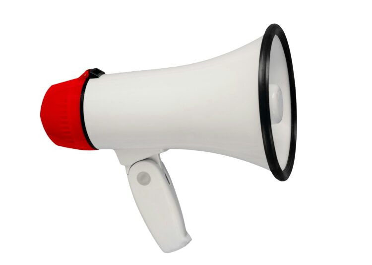 White and red megaphone isolated from background. Alarm and announcement